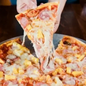 Hawaiian pizza slice with ham and pineapple at Jonny's Pizza in Aubrey and Frisco, TX