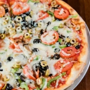 Veggie Lovers pizza with peppers, olives, and mushrooms at Jonny's Pizza in Aubrey and Frisco, TX